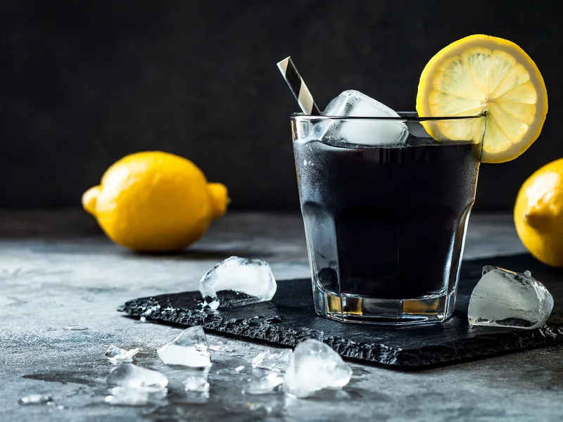 Activated charcoal lemonade with lemons and ice
