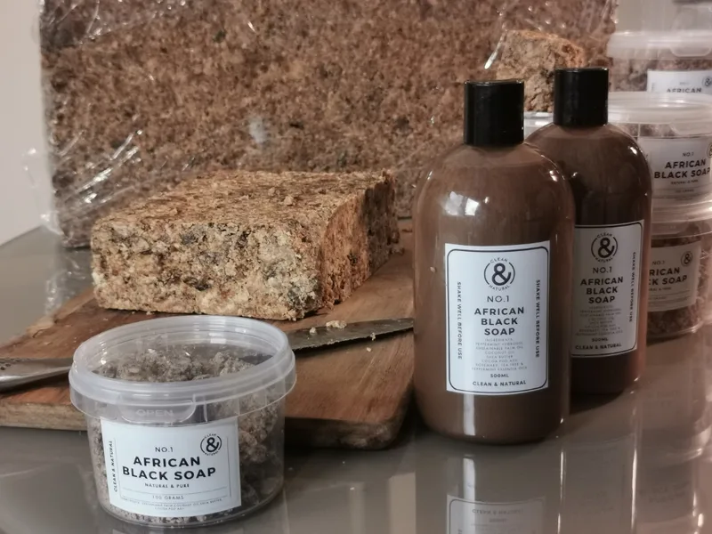 African black soap blocks and Clean & Natural skincare tub and bottles.